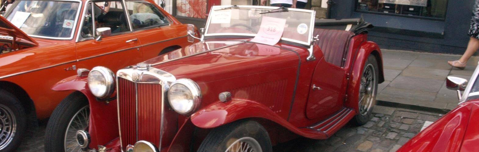 3 red vintage cars
